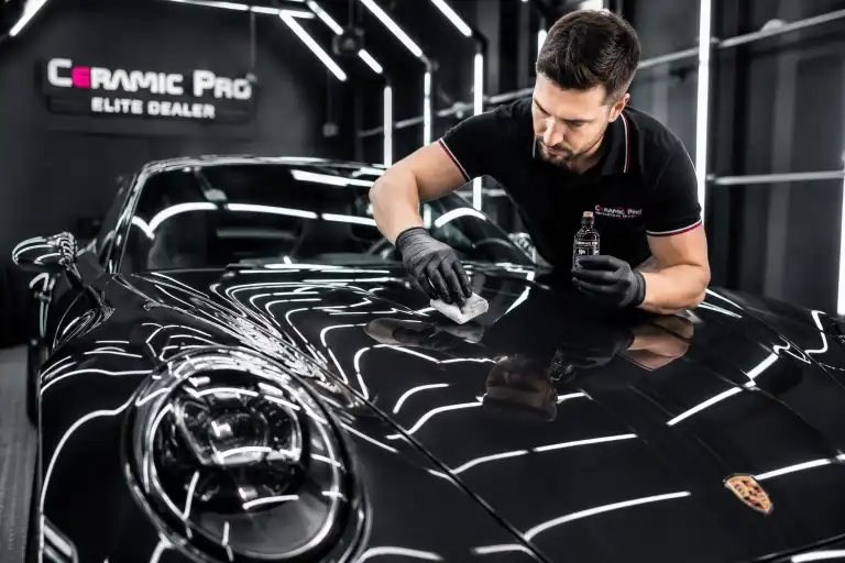 applying car protection film on a black car