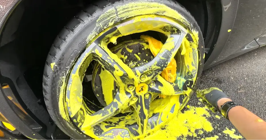 applying thick foam on wheel to remove brake dust
