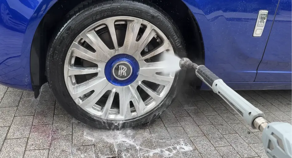 Removing brake dust from alloy wheels during professional car detailing in Richmond
